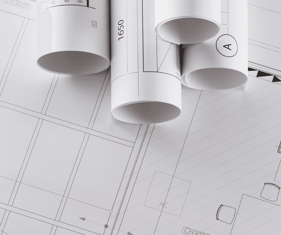 A lot of blueprints all together. There are four rolls at the top of floor plans and on spread out across the whole image as a background.